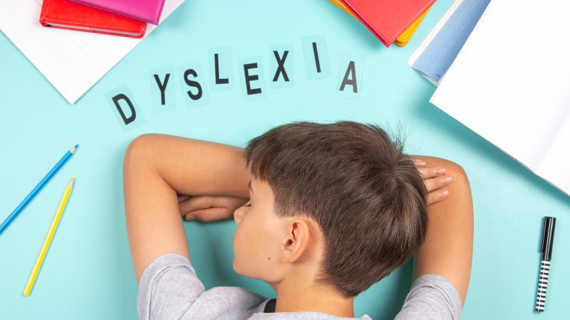 Child spelling with plastic letters on a table, Do I Have Dyslexia